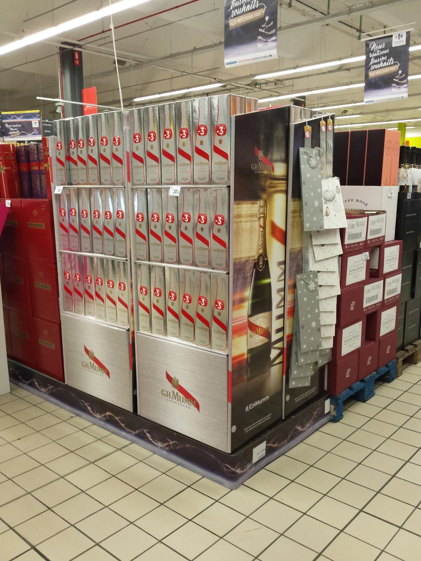 Silver Mumm display holding product boxes